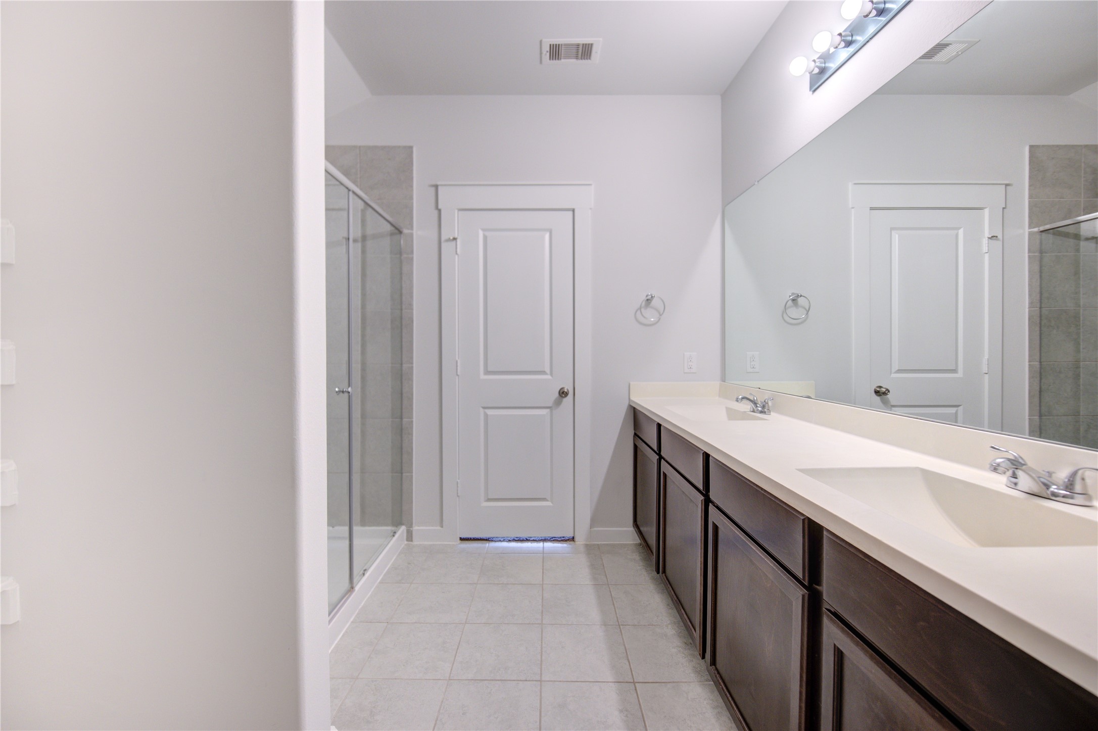 12326 Sabine Point Drive Humble, TX 77346 - Photo 26 of 42 a spacious bathroom with a double vanity sink and a mirror