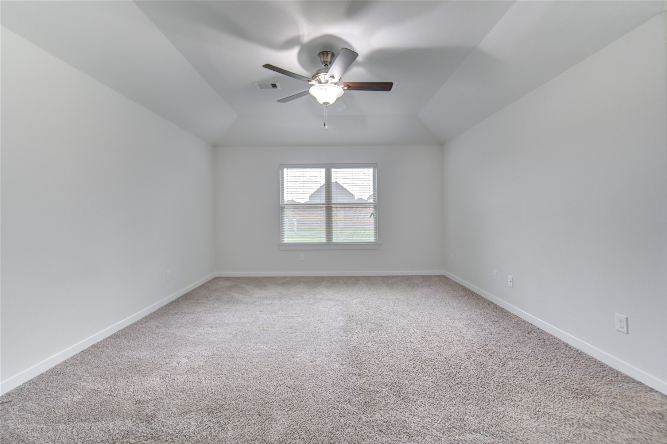 12326 Sabine Point Drive Humble, TX 77346 - Photo 28 of 42 an empty room with a chandelier fan and windows