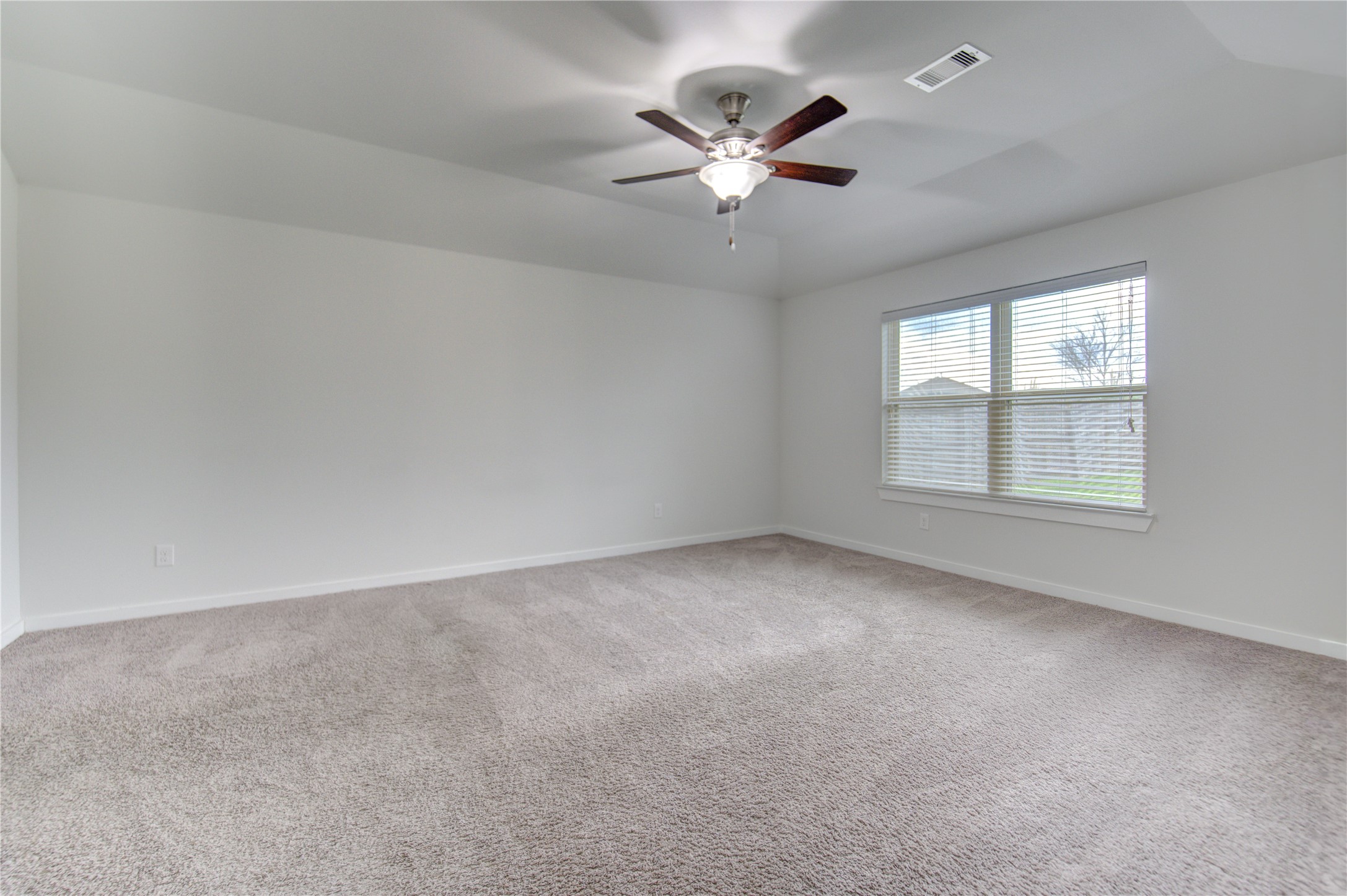 12326 Sabine Point Drive Humble, TX 77346 - Photo 29 of 42 an empty room with windows and fan