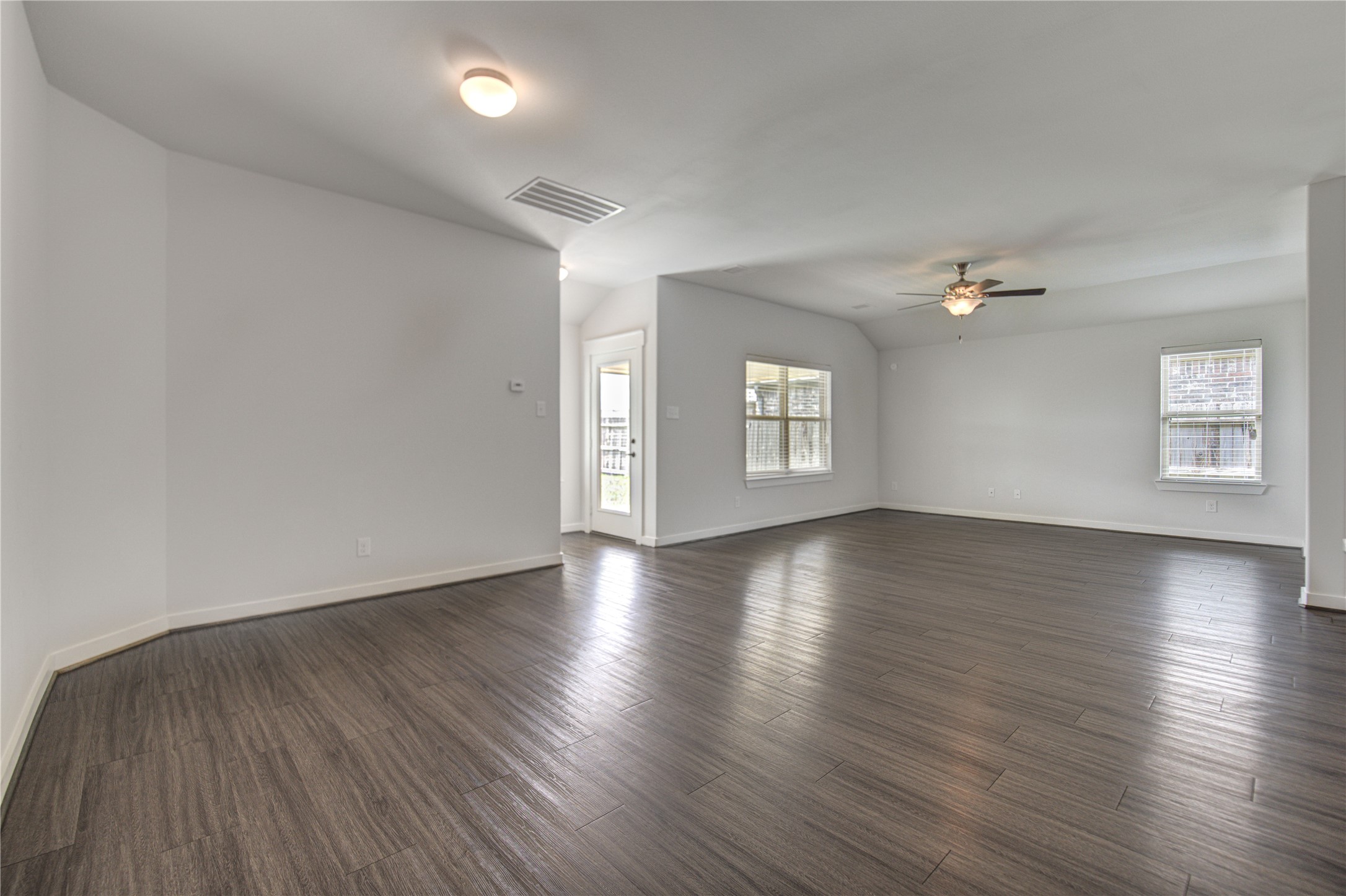 12326 Sabine Point Drive Humble, TX 77346 - Photo 8 of 42 an empty room with wooden floor and windows