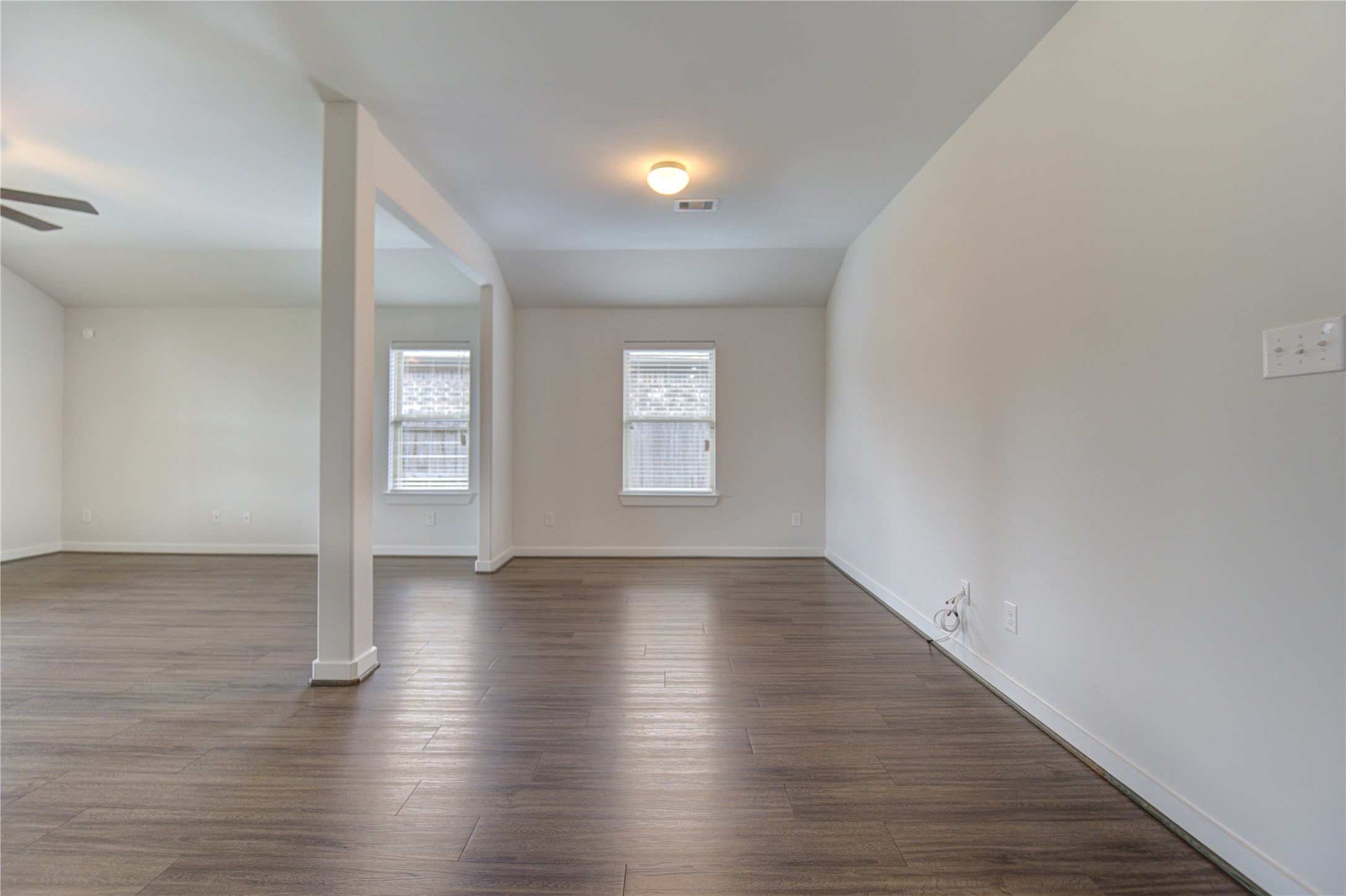 12326 Sabine Point Drive Humble, TX 77346 - Photo 10 of 42 a view of an empty room with wooden floor and a window