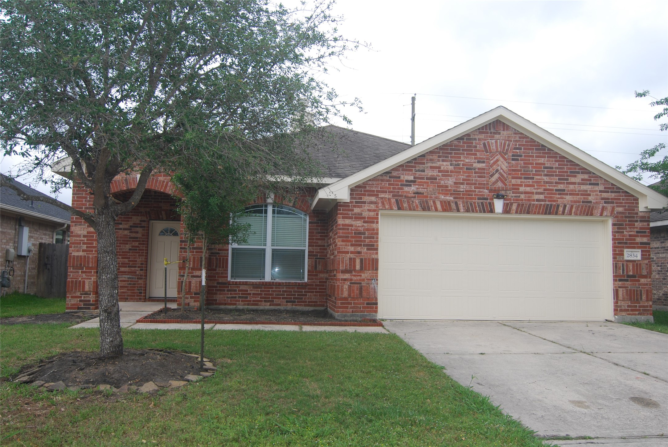 2834 Lockeridge Pines Drive Spring, TX 77386 - Photo 1 of 20 Charming single-story brick home with a cozy front porch and a well-maintained lawn. Features a two-car garage and a welcoming entryway.