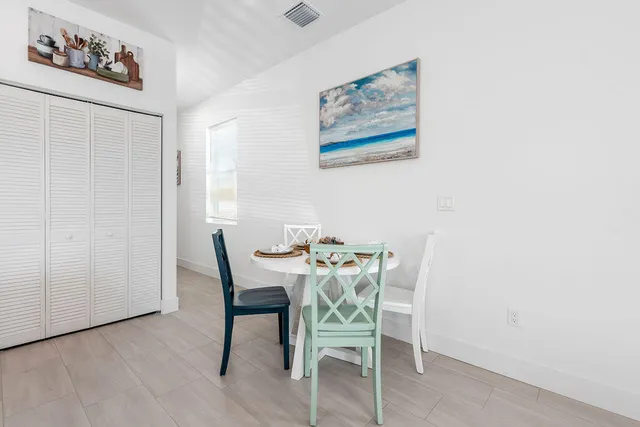 a dining room with furniture and wooden floor