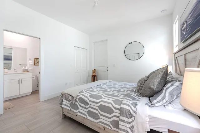 a bedroom with a bed and cabinets