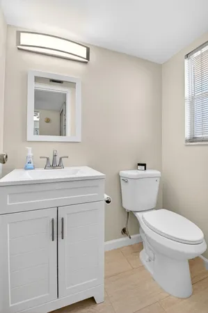 a bedroom with a bed a lamp and a window