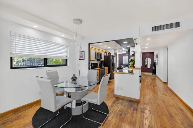 a dining room with furniture and wooden floor