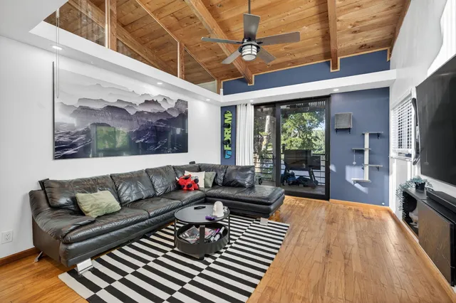 a living room with furniture a large window with outer view