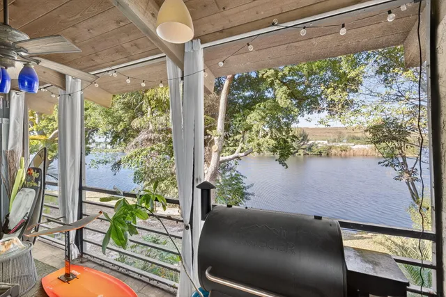 a vase of flowers sitting on a table with wooden floor