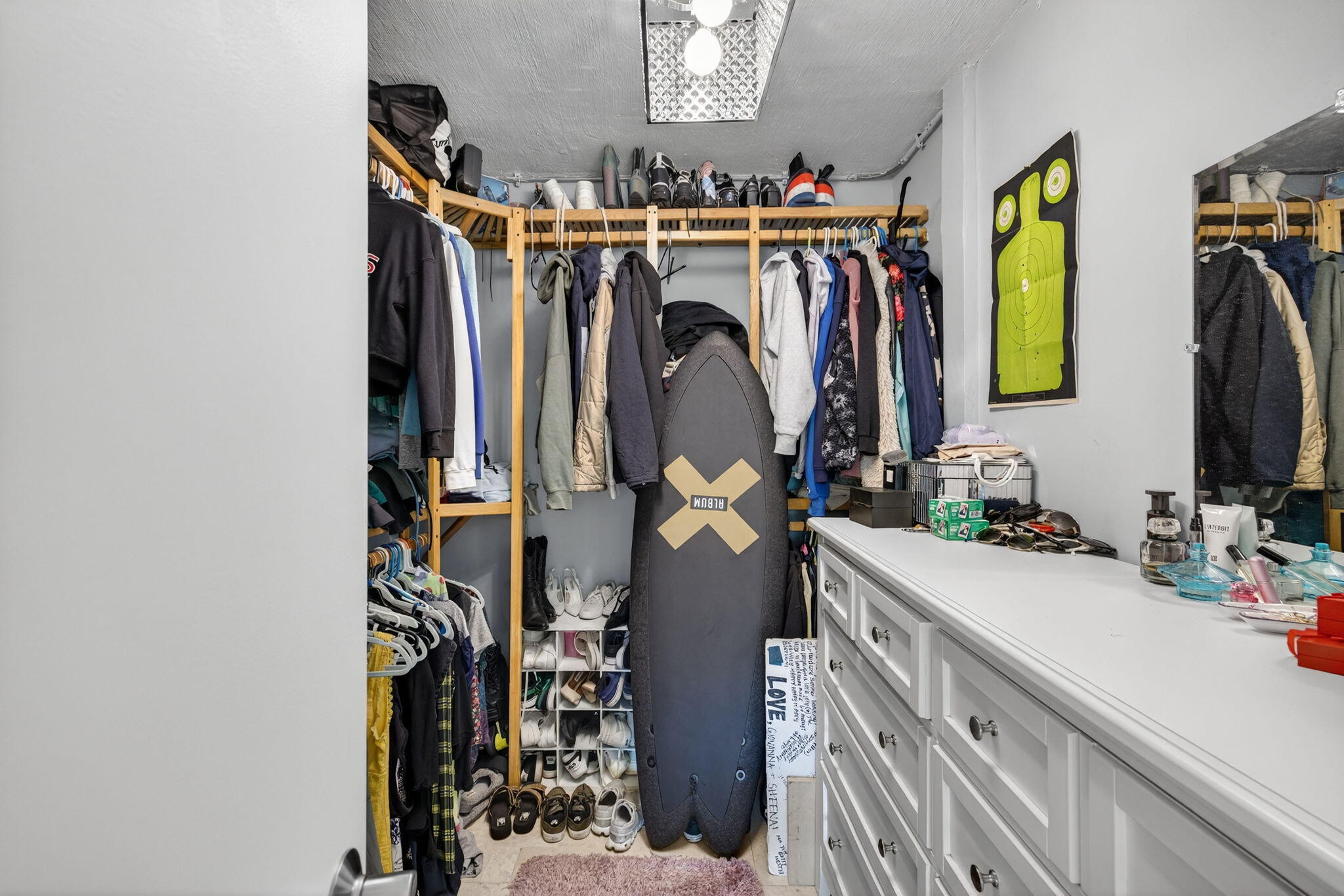 4491 Crystal Lake Drive, Unit 201A Deerfield Beach, FL 33073 - Photo 23 of 36 a view of walk in closet with clothes and shoes