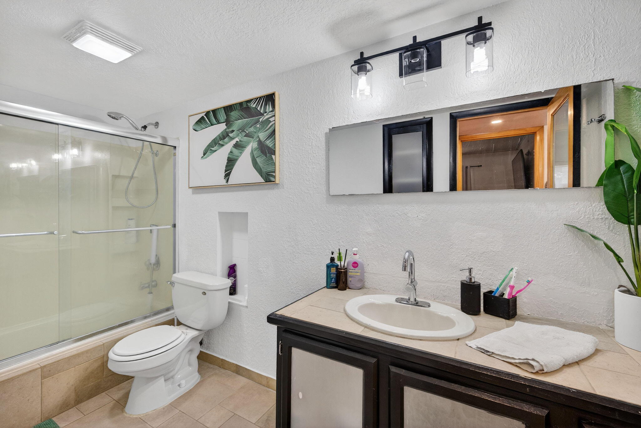 4491 Crystal Lake Drive, Unit 201A Deerfield Beach, FL 33073 - Photo 25 of 36 a bathroom with a sink a toilet and shower