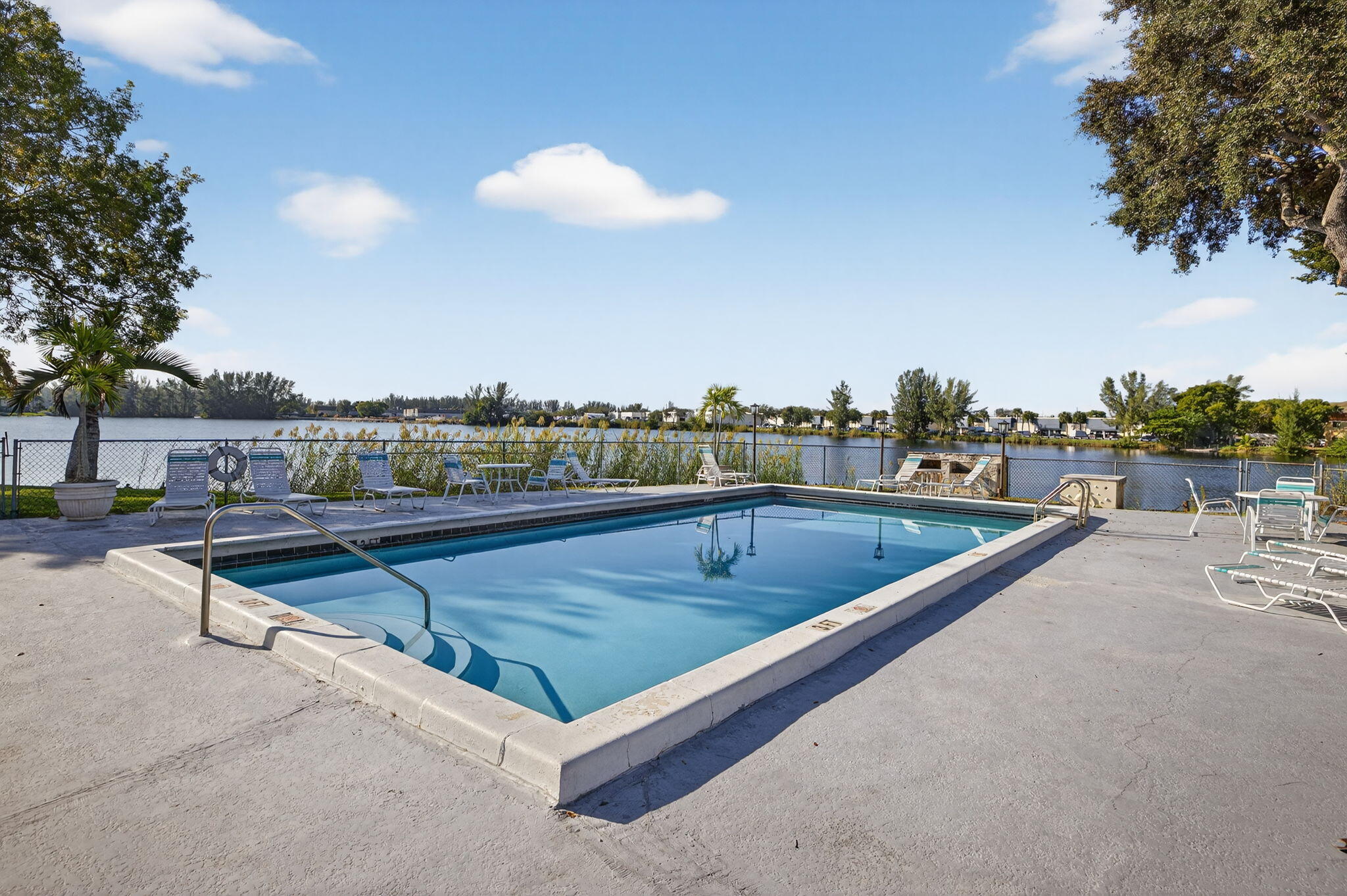 4491 Crystal Lake Drive, Unit 201A Deerfield Beach, FL 33073 - Photo 30 of 36 a view of swimming pool with outdoor seating and city view