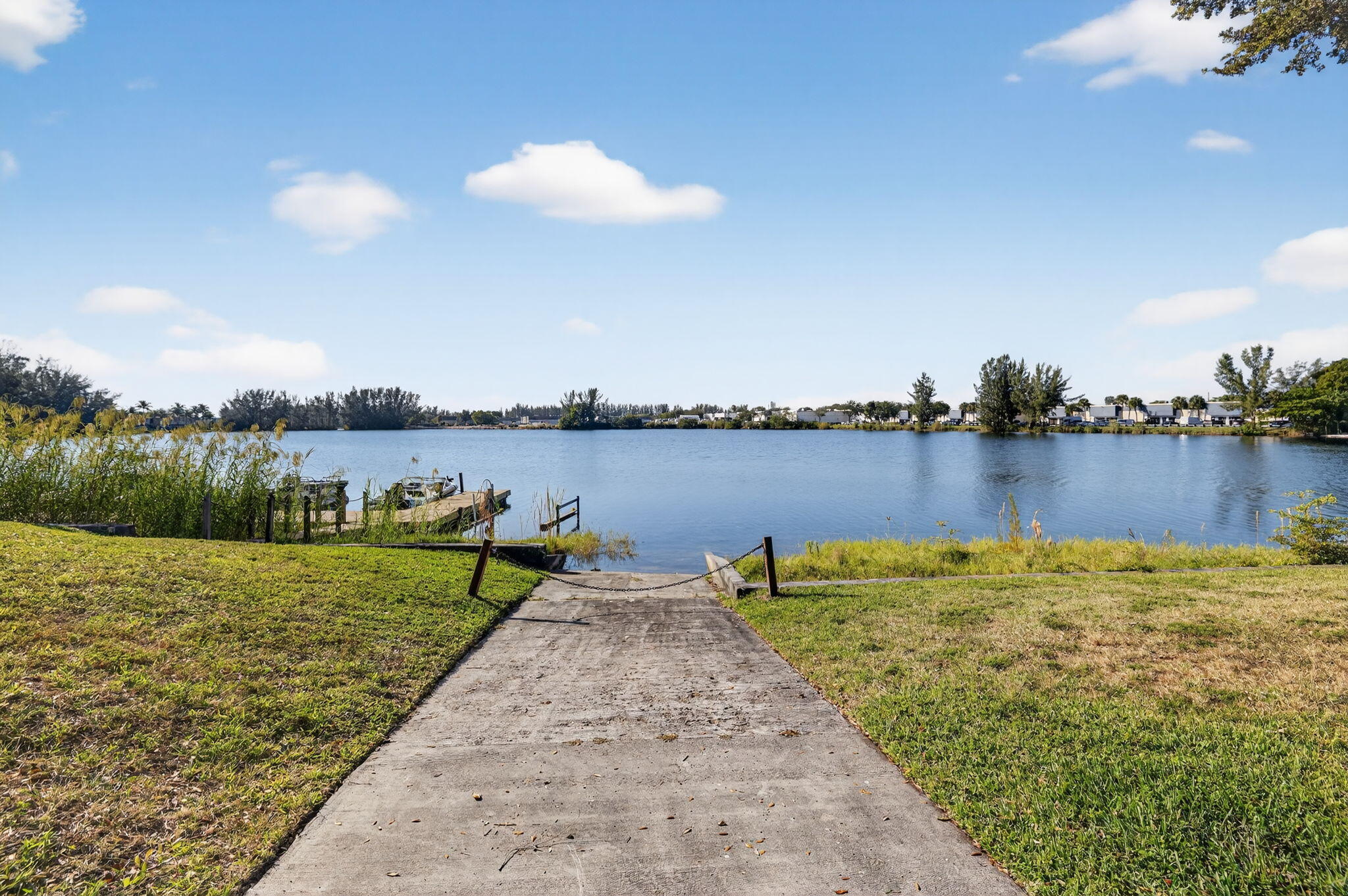 4491 Crystal Lake Drive, Unit 201A Deerfield Beach, FL 33073 - Photo 31 of 36 a view of a lake with houses in the back