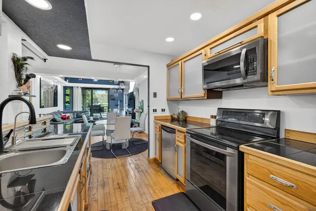 a kitchen with stainless steel appliances a stove sink microwave and cabinets
