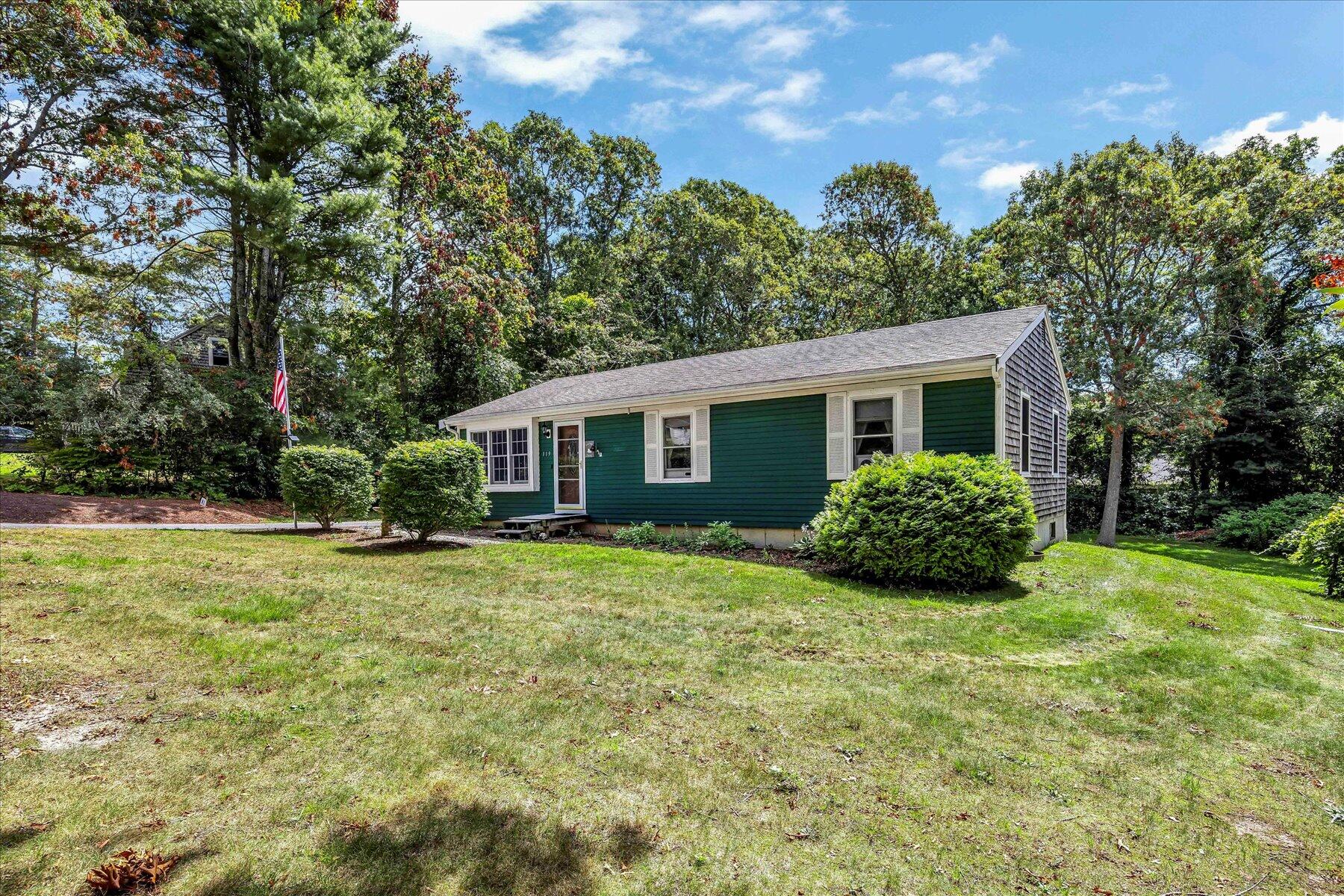 119 Scituate Road Mashpee, MA 02649 - Photo 1 of 1 a view of a house with a yard and potted plants