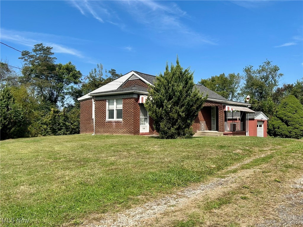 164 Locust Lane Follansbee, WV 26037 - Photo 19 of 19 View of front of house with a front lawn, brick siding, and covered porch