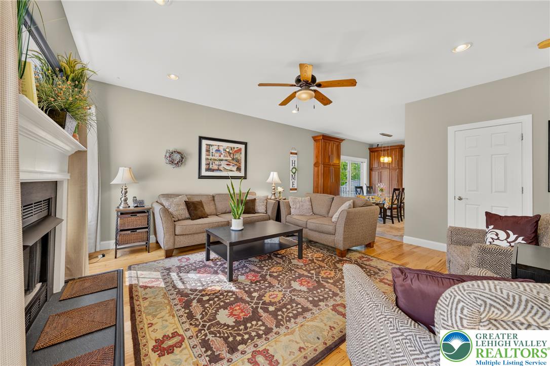 1702 Red Bud Road Quakertown, PA 18951 - Photo 22 of 68 A vibrant area rug anchors this inviting living space, connecting seamlessly to a sun-drenched dining area.