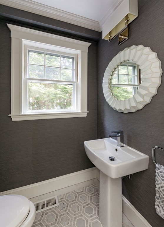 25 Bonad Road Newton, MA 02465 - Photo 12 of 26 a bathroom with a sink toilet and mirror