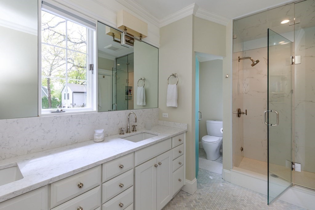 25 Bonad Road Newton, MA 02465 - Photo 15 of 26 a bathroom with a granite countertop sink a toilet and a shower