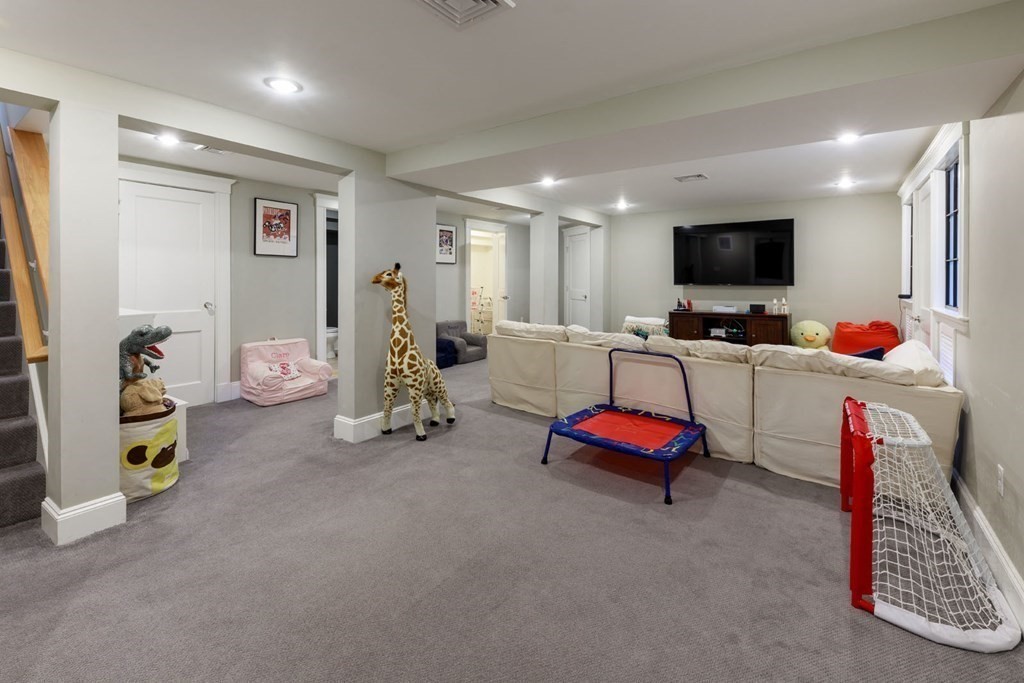 25 Bonad Road Newton, MA 02465 - Photo 20 of 26 a living room with furniture and a flat screen tv