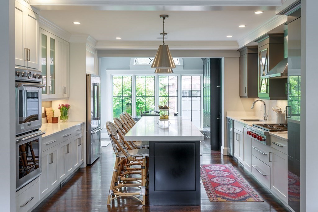 25 Bonad Road Newton, MA 02465 - Photo 4 of 26 a kitchen with stainless steel appliances granite countertop a sink and a stove