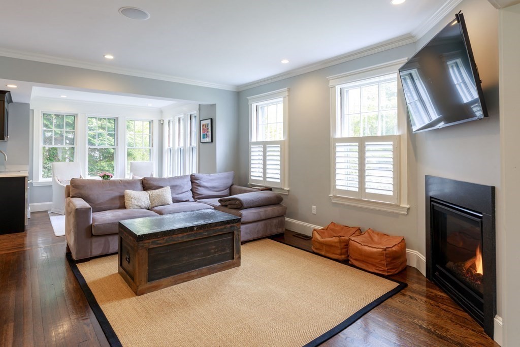 25 Bonad Road Newton, MA 02465 - Photo 6 of 26 a living room with furniture wooden floor and a fireplace