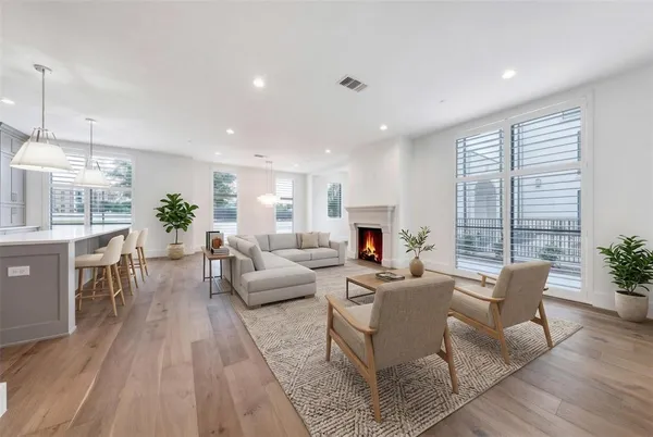 a living room with furniture fireplace and a table