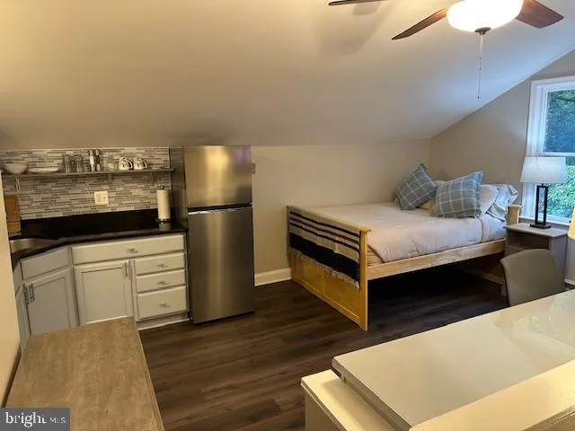 a living room with a bed furniture and a window