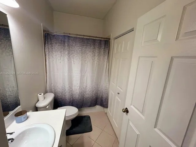 a bathroom with a toilet a sink and a shower