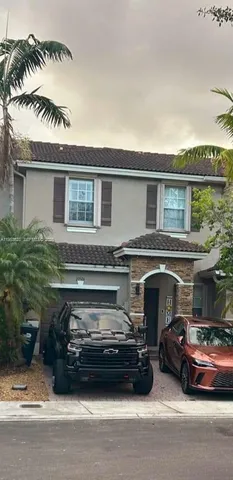a view of a car parked in front of a house
