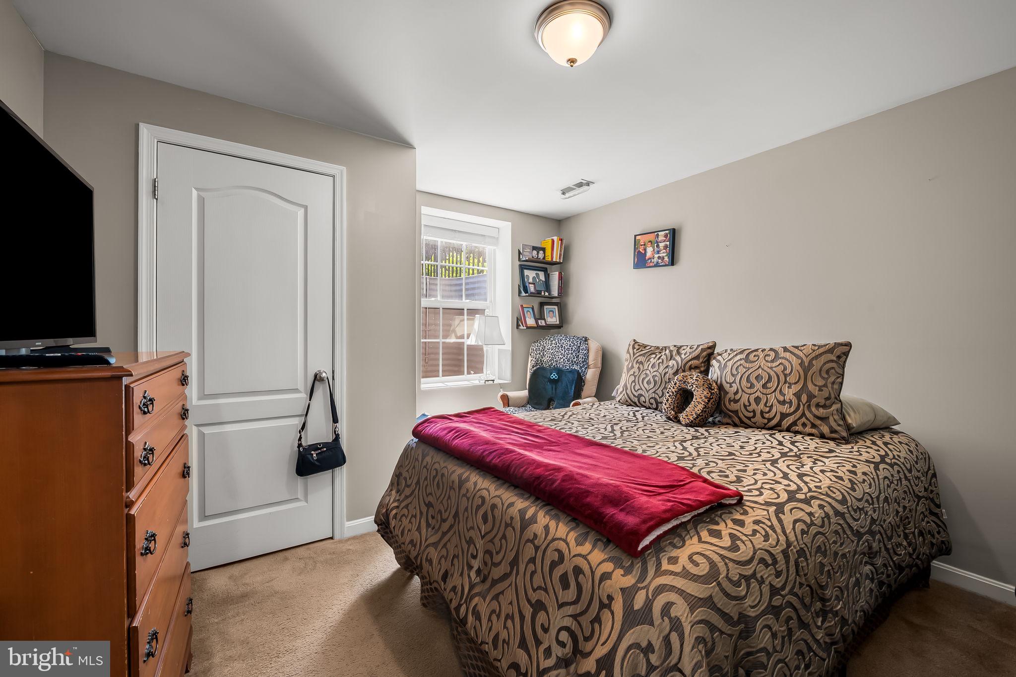 6008 Hanover Road Elkridge, MD 21075 - Photo 28 of 36 a bedroom with a bed and a flat screen tv