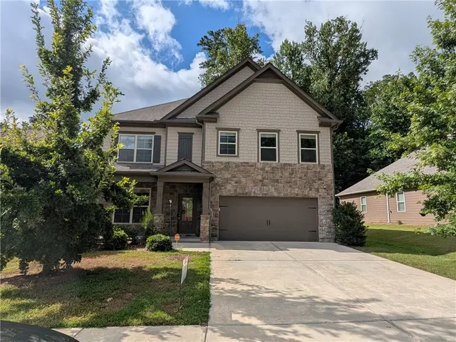 a front view of a house with a yard