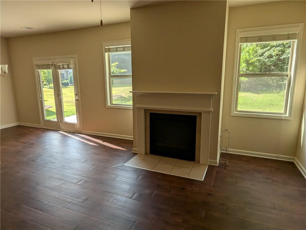 105 Whitney Way Dallas, GA 30157 - Photo 11 of 30 an empty room with wooden floor fireplace and windows