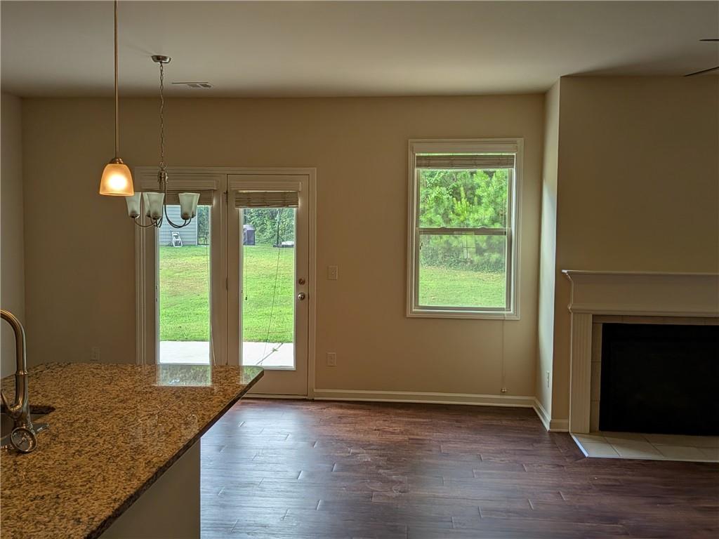 105 Whitney Way Dallas, GA 30157 - Photo 12 of 30 a view of an empty room with window and wooden floor