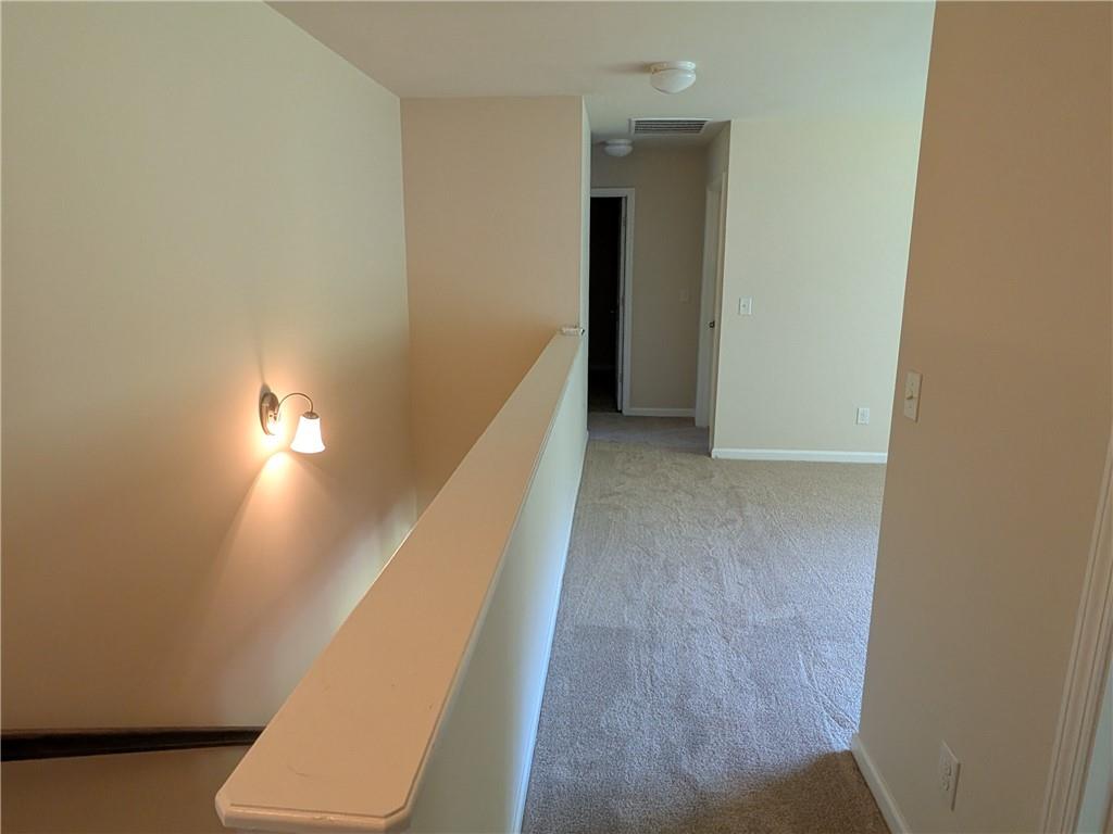105 Whitney Way Dallas, GA 30157 - Photo 14 of 30 a view of a hallway with wooden floor and staircase