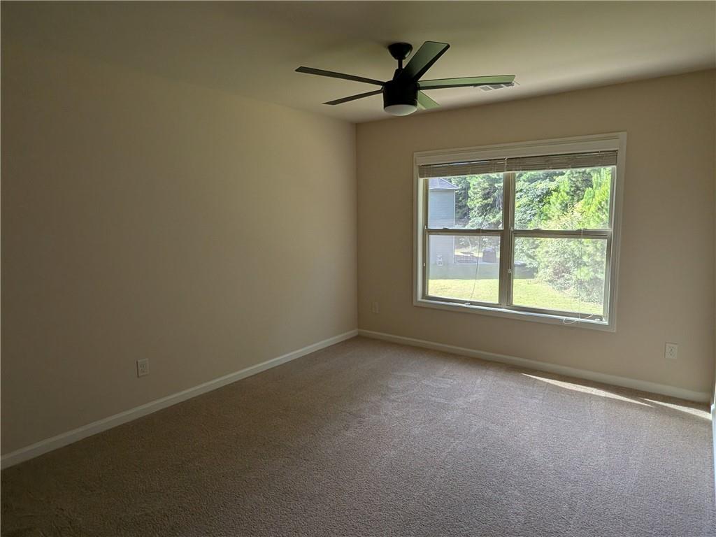 105 Whitney Way Dallas, GA 30157 - Photo 18 of 30 an empty room with a window and a ceiling fan