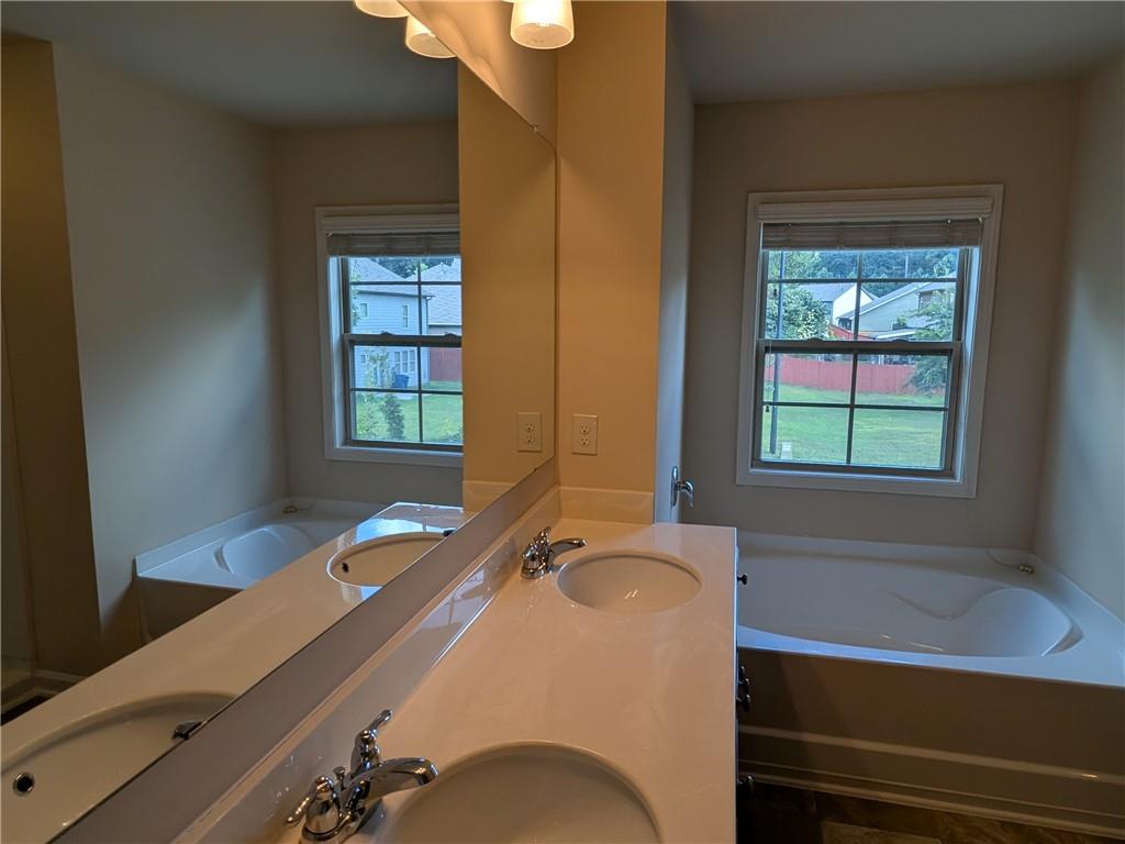 105 Whitney Way Dallas, GA 30157 - Photo 19 of 30 a bathroom with a tub and a sink