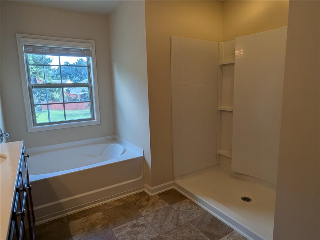 105 Whitney Way Dallas, GA 30157 - Photo 20 of 30 a bathroom with a tub and shower