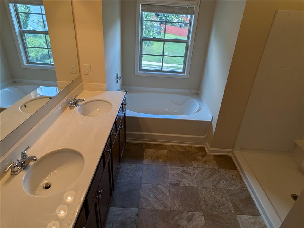 105 Whitney Way Dallas, GA 30157 - Photo 21 of 30 a bathroom with a tub sink and mirror