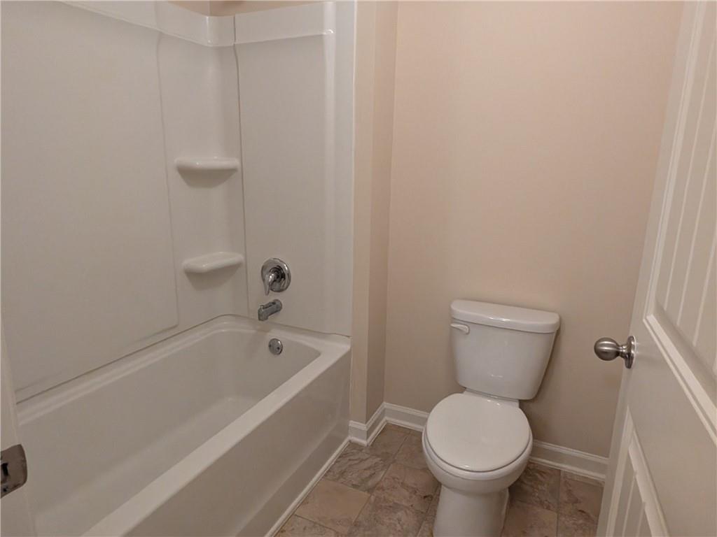 105 Whitney Way Dallas, GA 30157 - Photo 24 of 30 a bathroom with a toilet and a bathtub
