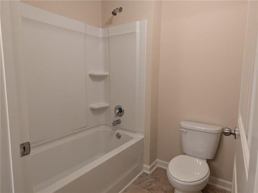 105 Whitney Way Dallas, GA 30157 - Photo 26 of 30 a white toilet sitting next to a bathtub
