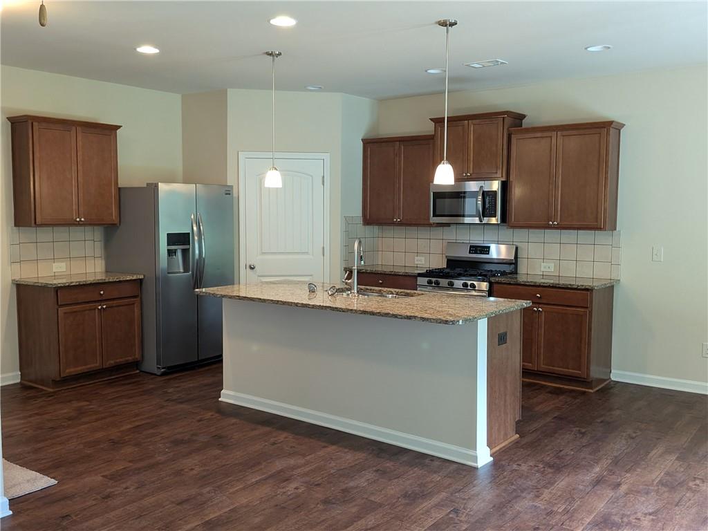 105 Whitney Way Dallas, GA 30157 - Photo 4 of 30 a kitchen with a sink cabinets and wooden floor