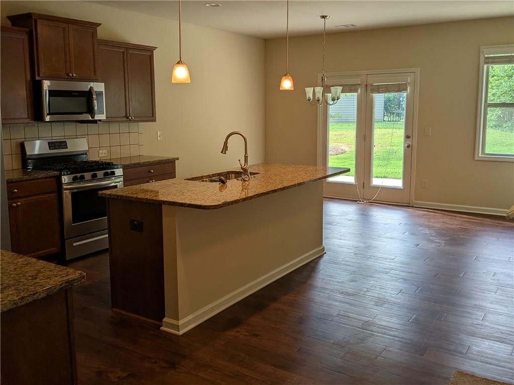 105 Whitney Way Dallas, GA 30157 - Photo 9 of 30 a kitchen with stainless steel appliances granite countertop a stove a sink and a microwave