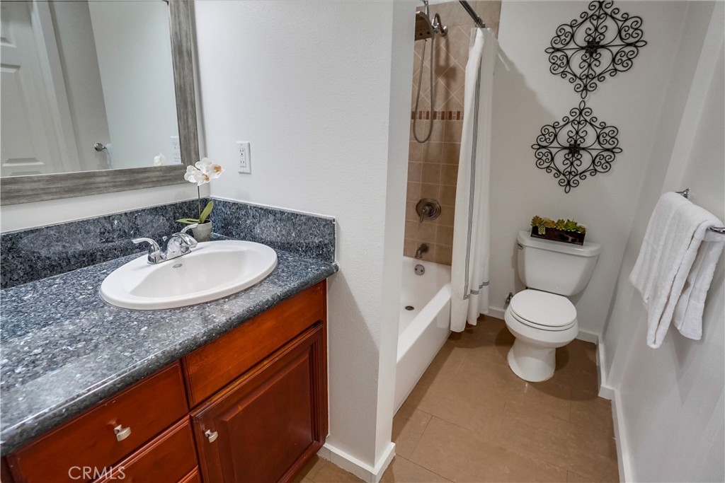 4037 East 7th Street Long Beach, CA 90804 - Photo 11 of 13 a bathroom with a granite countertop sink toilet and shower