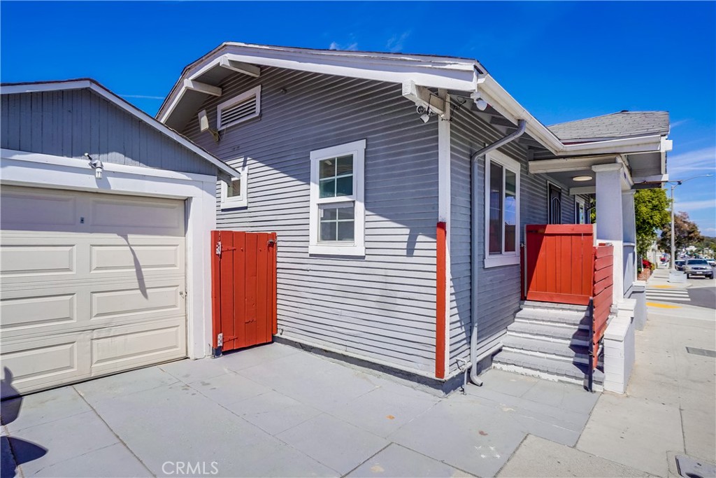 4037 East 7th Street Long Beach, CA 90804 - Photo 2 of 13 a view of wooden house with a small yard