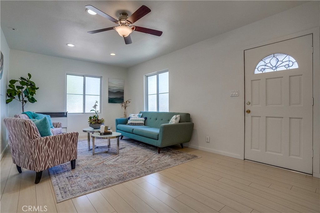 4037 East 7th Street Long Beach, CA 90804 - Photo 3 of 13 a living room with furniture and a chandelier