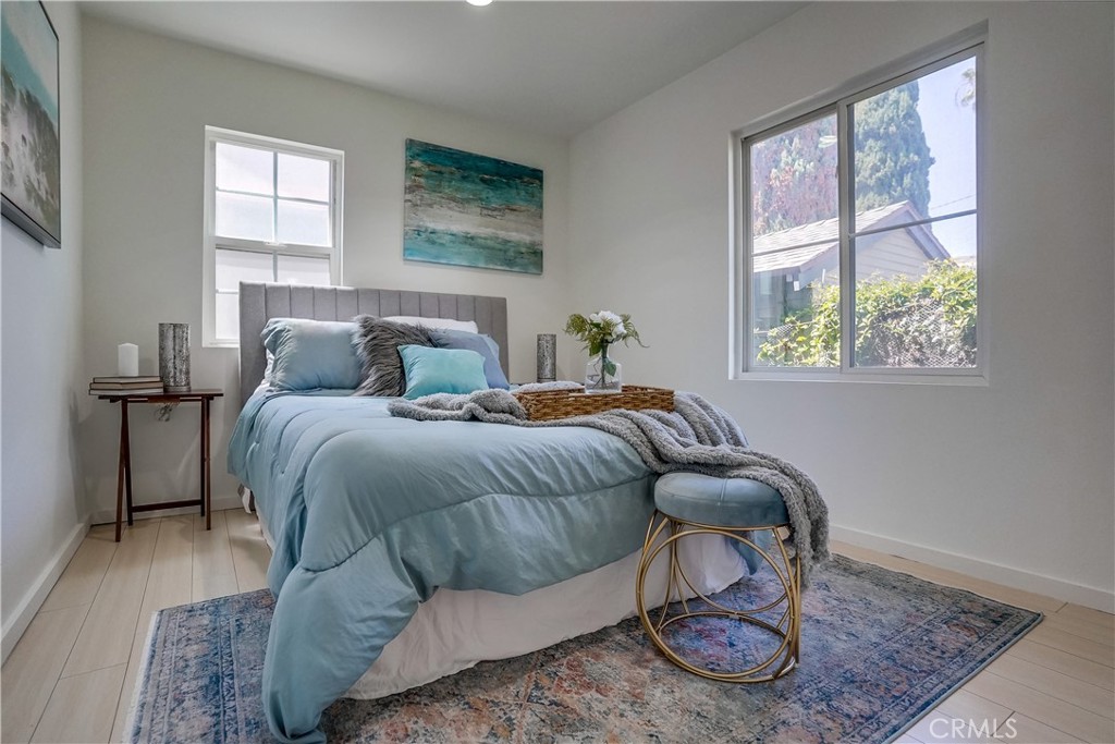 4037 East 7th Street Long Beach, CA 90804 - Photo 10 of 13 a bedroom with a bed and wooden floor