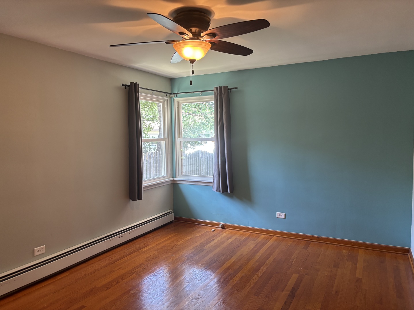 1378 East Street Crete, IL 60417 - Photo 11 of 12 an empty room with wooden floor and windows