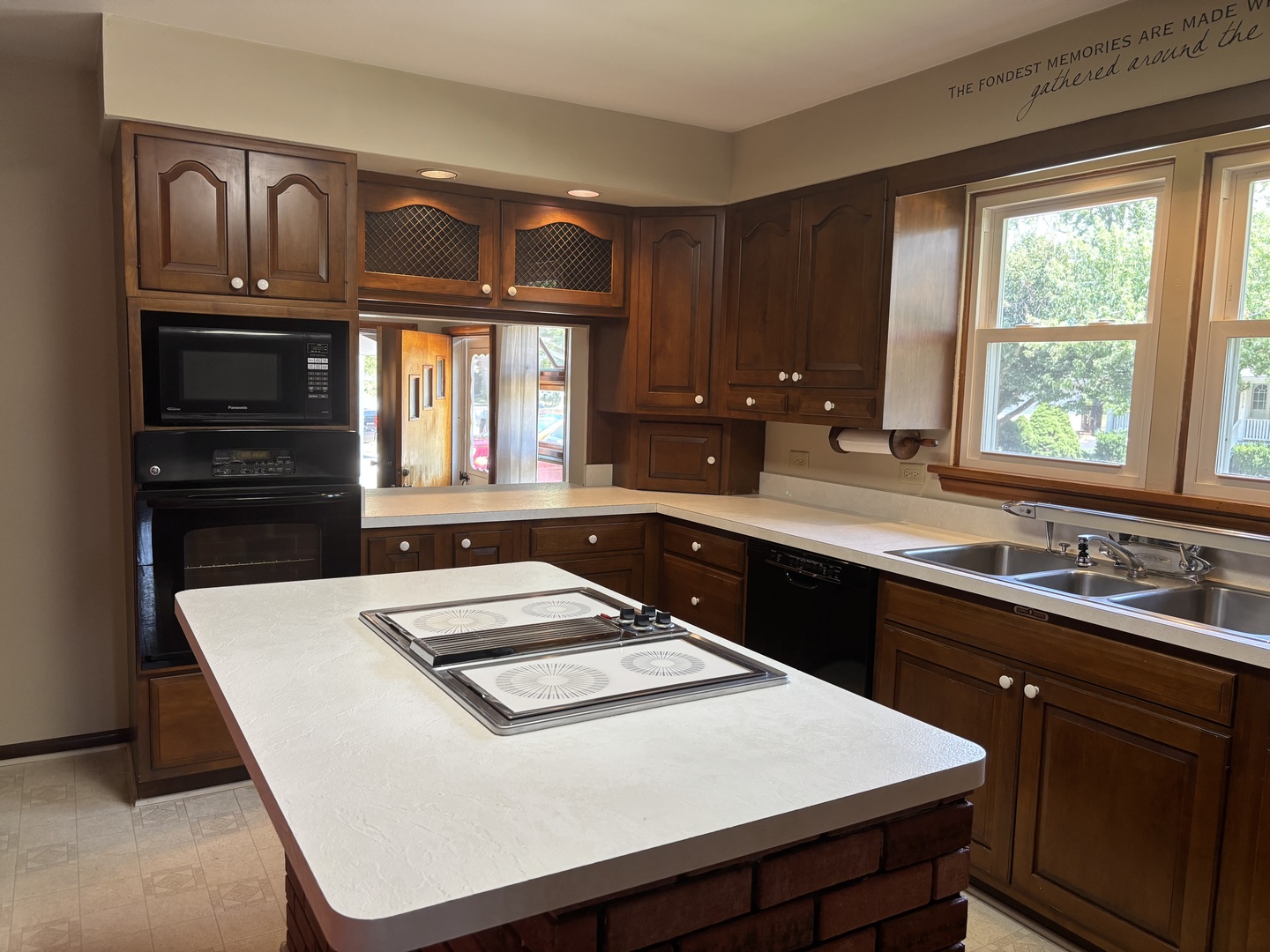 1378 East Street Crete, IL 60417 - Photo 4 of 12 a kitchen with kitchen island a sink stove and granite counter top