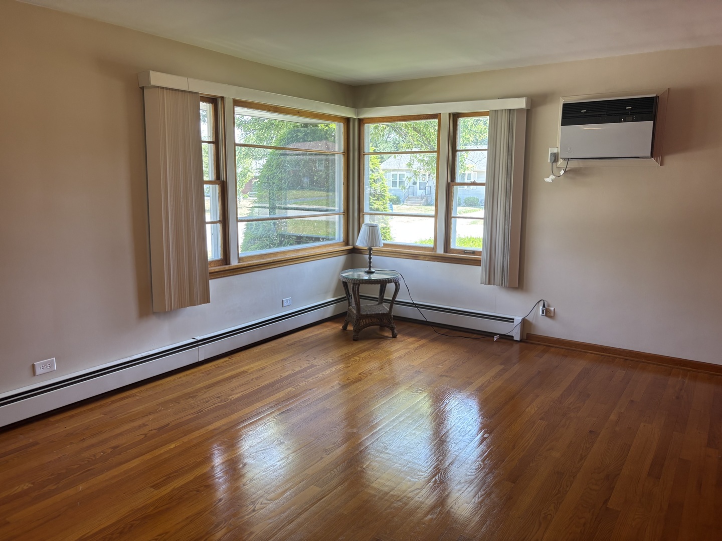 1378 East Street Crete, IL 60417 - Photo 7 of 12 a view of an empty room with wooden floor and a window