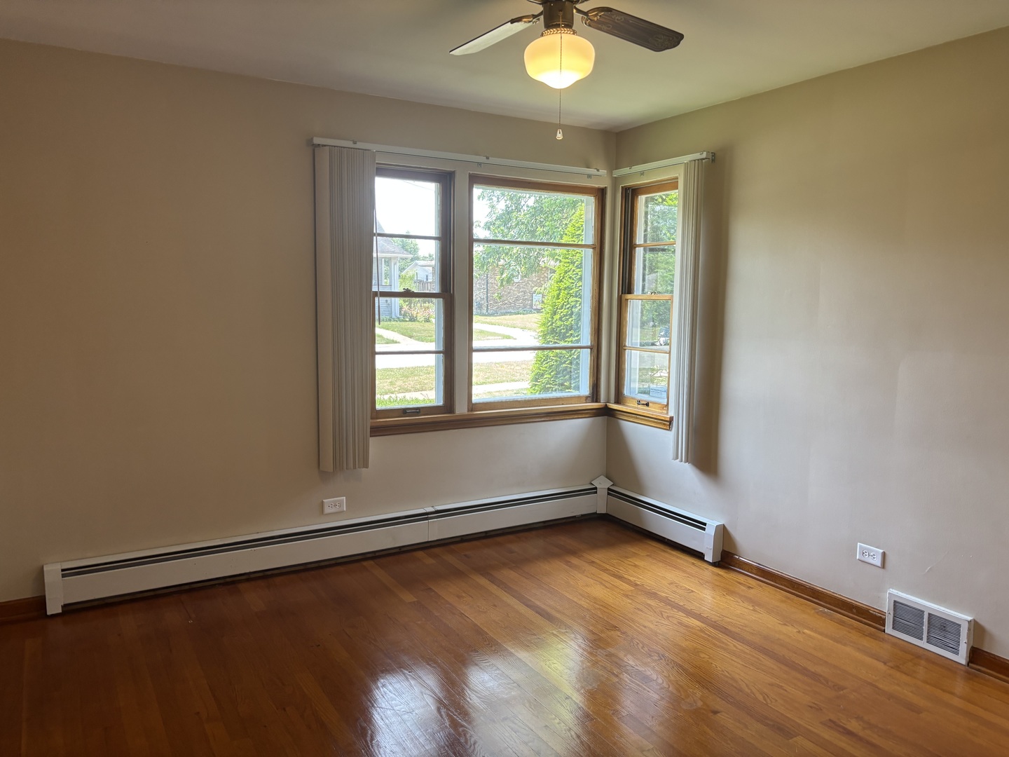1378 East Street Crete, IL 60417 - Photo 9 of 12 an empty room with wooden floor and windows